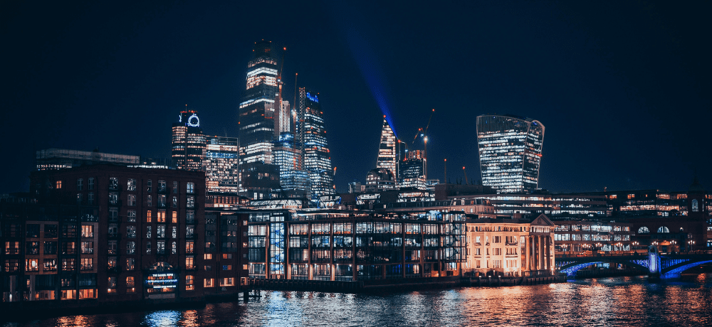 Image of London at night brightly lit from electricity.