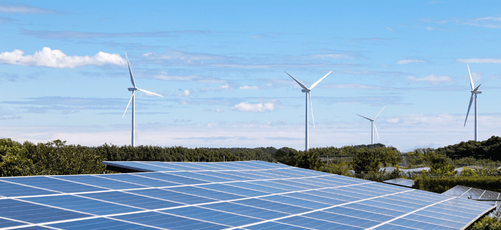 Image of solar panels and wind turbines.