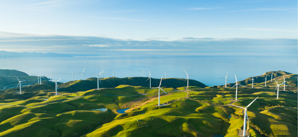 Header image of a hilly landscape with wind turbines.